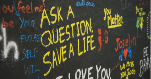 graffiti that reads ask a question save a life